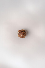 Homemade muffin with powdered sugar on white background