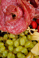 Salami, grapes, cheese, nuts, and fruit platter