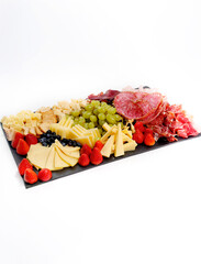 Charcuterie board with cheese, cured meats and fruits