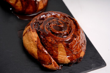 Chocolate cinnamon roll drizzling rich sweet syrup