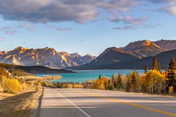 Autumn road to turquoise lake and mountains in Alberta, Canada