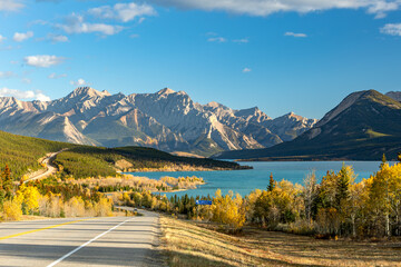 Autumn road to turquoise lake and mountains in Alberta, Canada