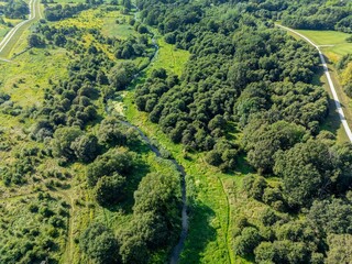 Aerial view of the Widawa River near Wrocław, Poland, with bike paths on flood embankments
