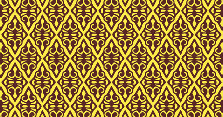 Brown and yellow diamond-shaped geometric pattern with intricate symmetrical motifs forming a repeating ornamental structure.