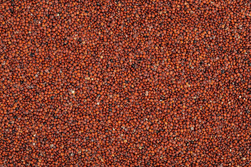 red quinoa seeds as a background. Top view. Flat lay