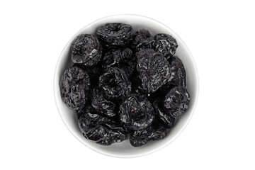 Prunes in ceramic bowl isolated on white background, heap of dried plums. Top view. Flat lay