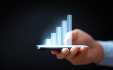 Business growth concept with technology. Hand holding smartphone projecting futuristic hologram chart. Financial data graph showing success, profit and analysis