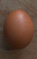 Egg with shell on wooden background