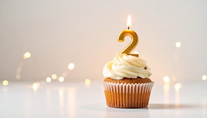 A Delicious Cupcake Celebrates a Second Birthday with a Lit Candle and Creamy Frosting