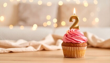 Delicious Birthday Cupcake with Number Two Candle on Wooden Table for a Second Birthday
