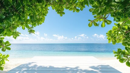White platform on beach framed by leafy greens and a large branch, blue sky enhances clean tropical aesthetic
