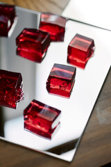 Red jelly on a mirrored metal tray