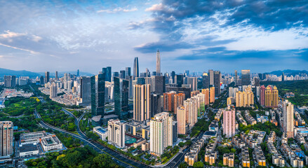Fototapeta premium Modern city skyline and financial district surrounded by green parks on a sunny day in Shenzhen.