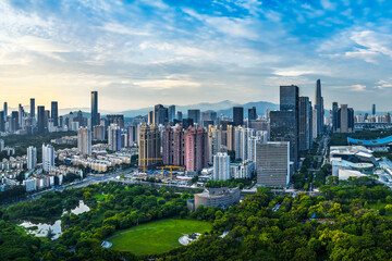 Obraz premium Aerial view of the downtown financial district skyline with modern office buildings and lush green space in Shenzhen.