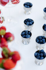 Fresh berries in the bright sun on the dessert table