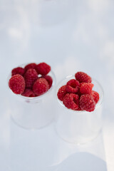 Fresh berries in the bright sun on the dessert table