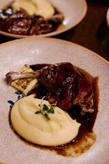 Chicken fillet, Jerusalem artichoke puree, dewberry sauce, potato, quail egg. Delicious healthy traditional food closeup served for lunch in modern gourmet cuisine restaurant.