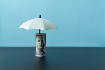 Wooden doll figures on light blue background. Insurance cover concept