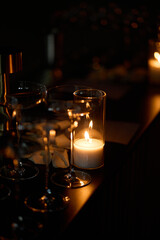 Empty clear glasses in the candlelight