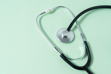 Stethoscope on light green background