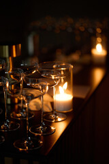 Empty clear glasses in the candlelight