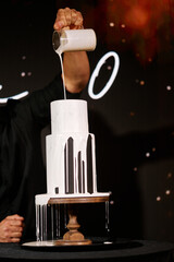 Black three-tiered cake with white cream