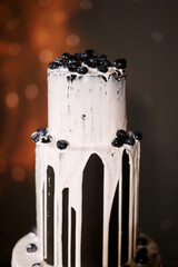 Black three-tiered cake with white cream