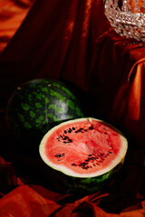 Holiday decorations with apricots, watermelons and medieval fabrics and chandeliers