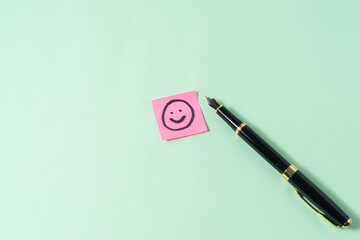 Business concept with a pen and smile emoji