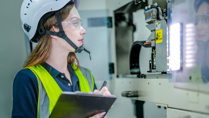 A female robotics engineer in an R and D lab. She is focused, concentrating on programming an AI...