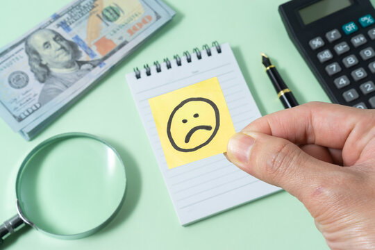 Business concept with a sad emoji