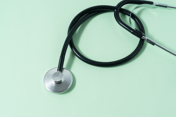 A stethoscope on light green background