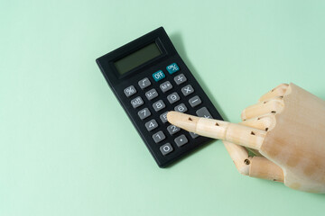 Business concept with a calculator on light green background