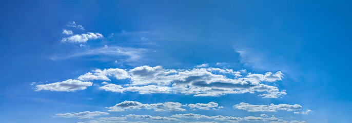 A group of clouds in the form of a wide panorama. Blue background with space for text and a light blue gradient. Violet Sky with Cloud Summer Spring Nature Light on Beautiful Natural sky Backdrop.