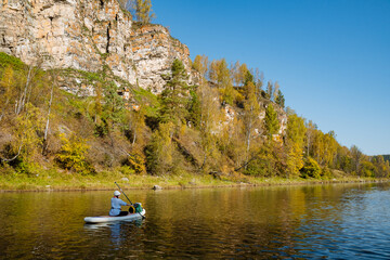 Experience a peaceful kayaking adventure on a picturesque river, perfectly surrounded by stunning...