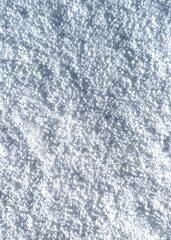 Background of fresh snow haill texture. Top view of the natural pure snow in winter with copy space. Beautiful abstract and contrast snowy white texture for design. Christmas background.