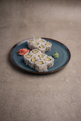 avocado sushi rolls on a blue plate with wasabi 
