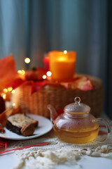 Relaxing fall scene with warm drink, dessert, and natural autumn colors.