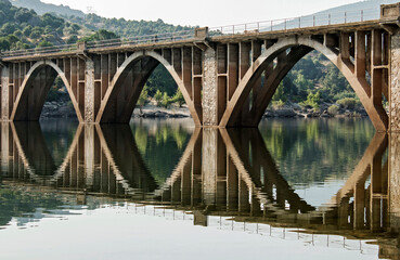 A bridge and its reflection on the water