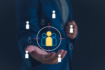 Target audience and customer segmentation concept with business hand holding virtual people icons in focus. Ideal for marketing strategy, business analytics, CRM, and digital advertising visuals.
