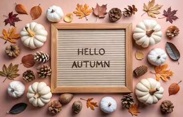 Autumn card with hello autumn text, pumpkins, pine cones and autumn decor