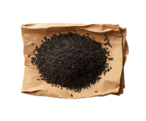 Black cumin seeds on a brown paper isolated on transparent background PNG