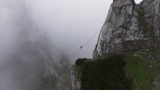 Adventurous hiker crossing a suspension bridge, Dachstein, Austria
