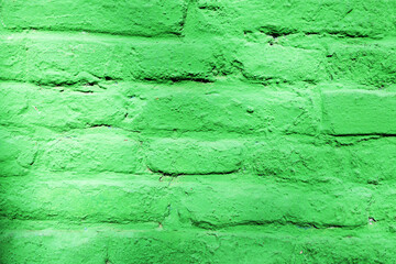 A brick wall painted green