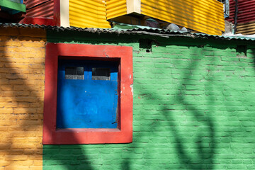 Window in the middle of a brick wall with various bright colors, La Boca, Buenos Aires