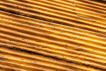 Tile wall painted yellow, photographed at a diagonal angle