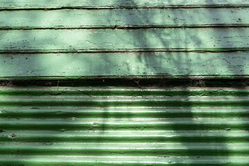 A green wall, half wood and half tile