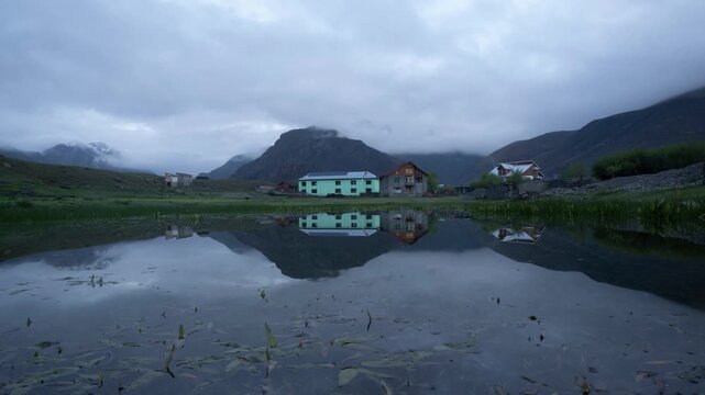 Reflection of house with tiger hills in backdrop, Drass, India 