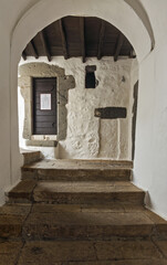 Interior of monastery,  religious paintings, arched doorway, ancient architecture, spiritual setting in the Monastery of Saint John the Theologian on the island of Patmos, Greece.