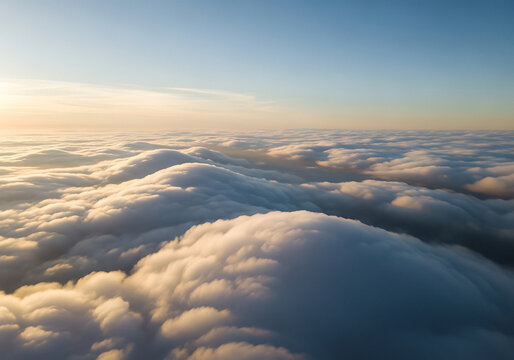 Aerial view of sunlit clouds at sunset with blue sky atmosphere